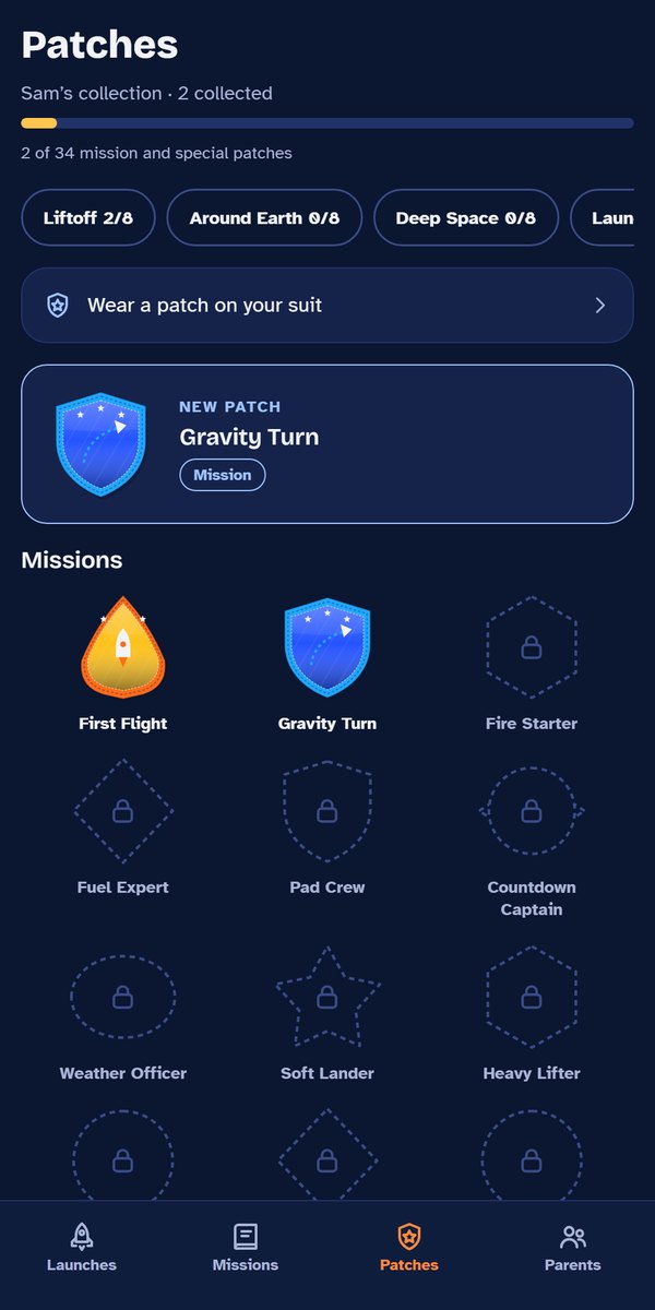 The Patches screen: two earned patches, First Flight and Gravity Turn, and locked patches still to earn.